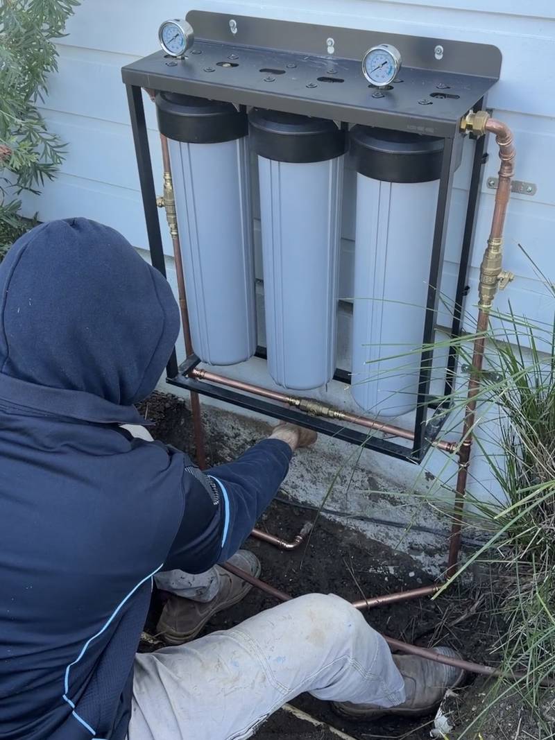 Max installing a three-stage whole-home water filtration system