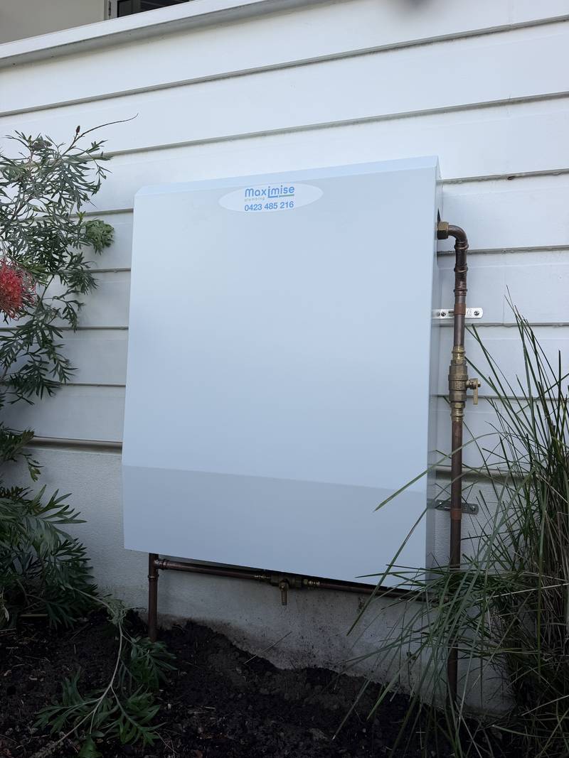 Completed filtration system behind a branded Maximise Plumbing weather cover