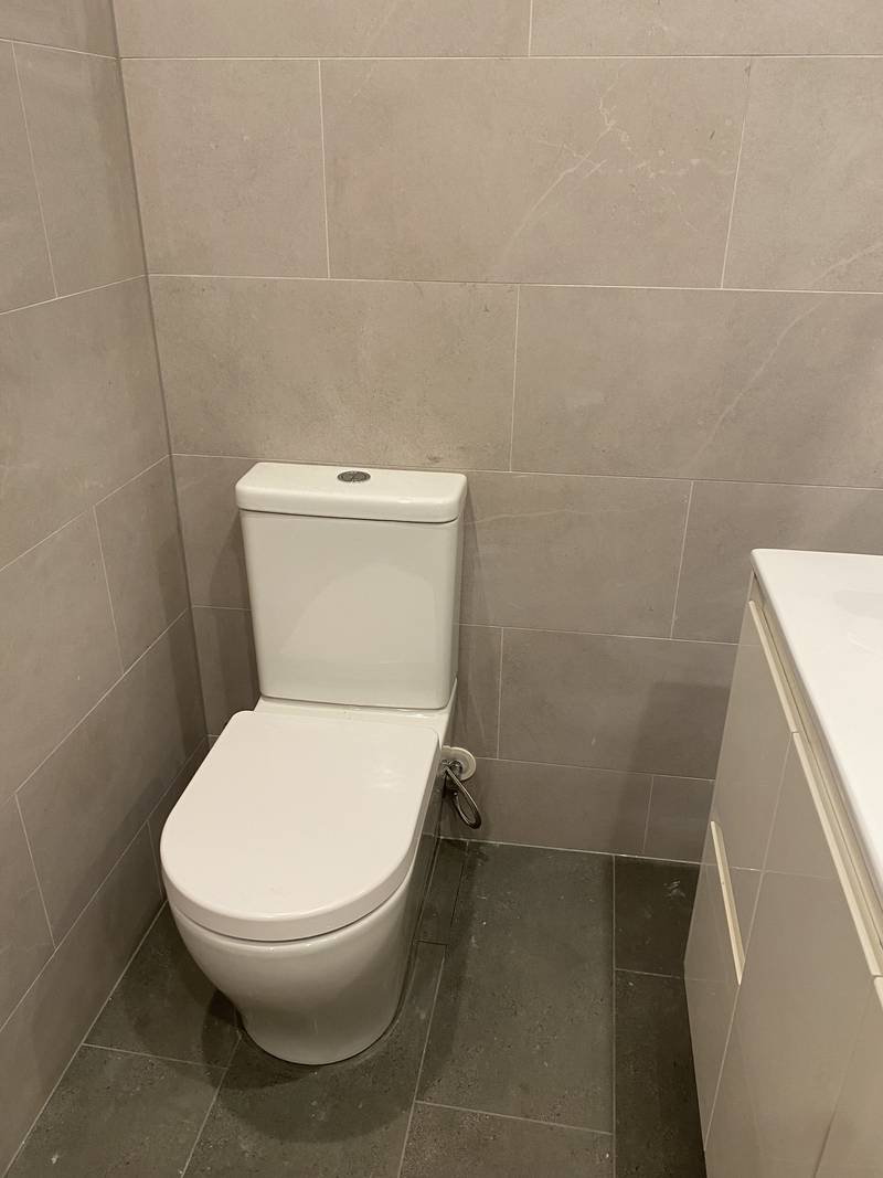 New toilet suite installed in a tiled bathroom