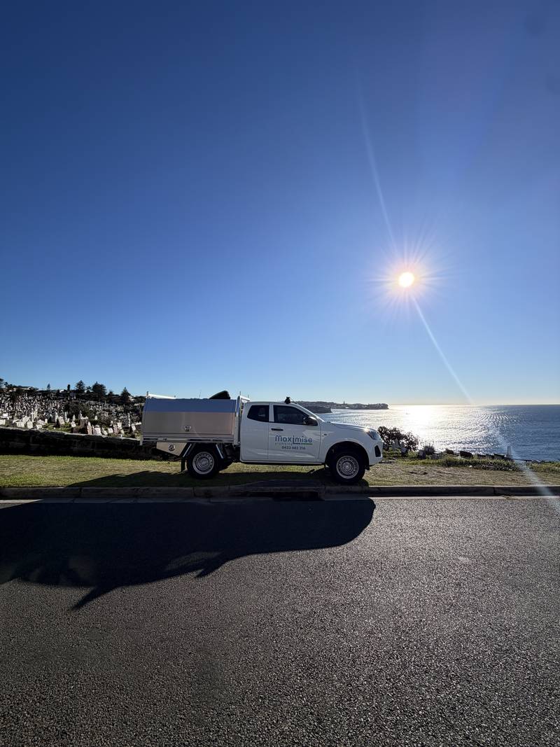 The Maximise Plumbing ute parked above the coast in the Eastern Suburbs