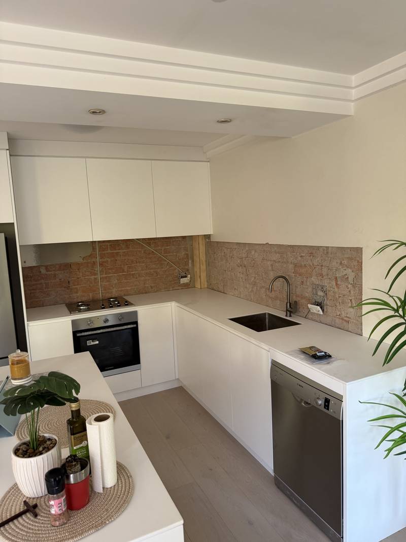 Renovated kitchen with new sink, mixer tap and dishwasher connection