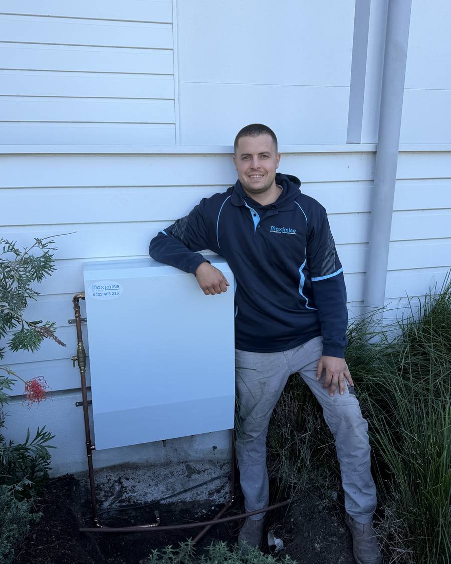 Max from Maximise Plumbing beside a completed whole-home water filtration installation